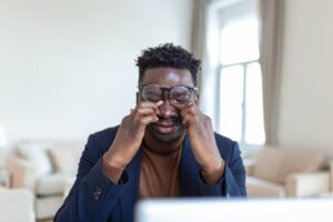 Young man with eye strain