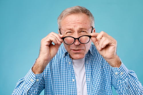 Mature male having trouble with his glasses prescription